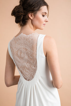 
                  
                    a woman in a white dress holding a cell phone 
                  
                