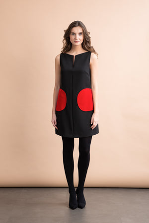 
                  
                    a woman in a black dress and a black backpack 
                  
                